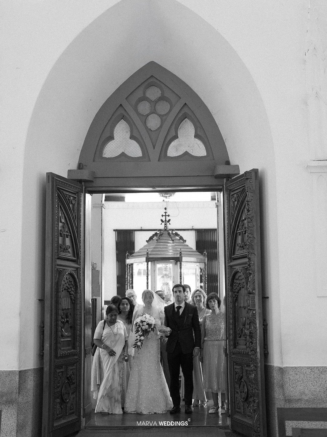 Bride entering a church with her wedding party